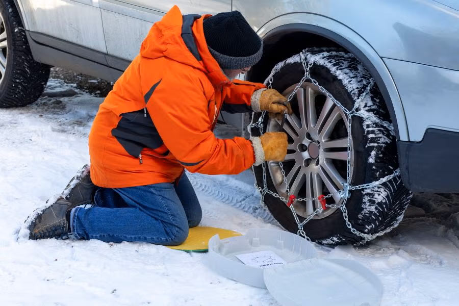 Putting snow chains on tire