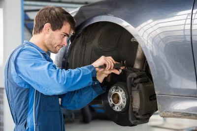Man repairing car brake pad