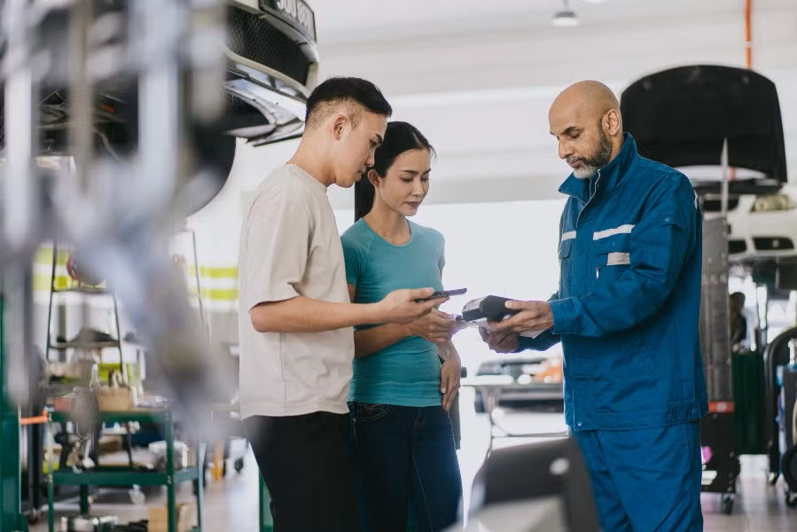 Technician discussing with the car owner